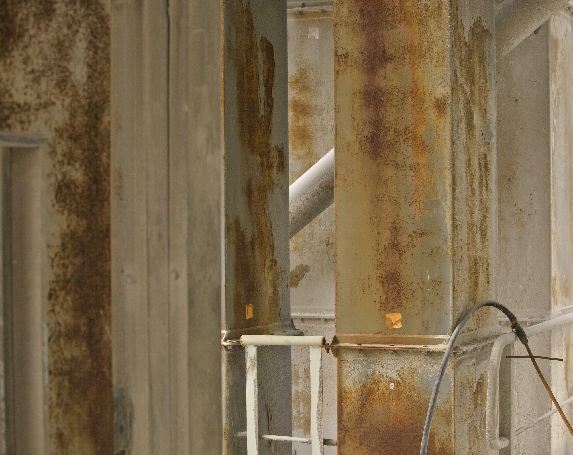 Rusty pillars on cement factory